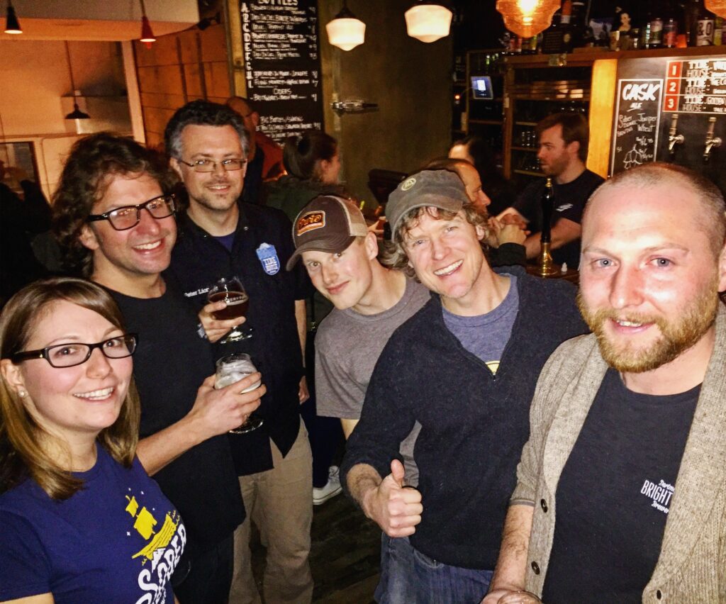 Rebecca of Sober Island Brewing with a group of guys.